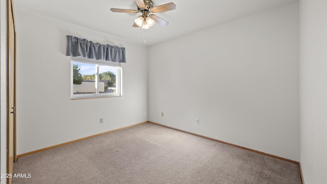 unfurnished room with ceiling fan and carpet