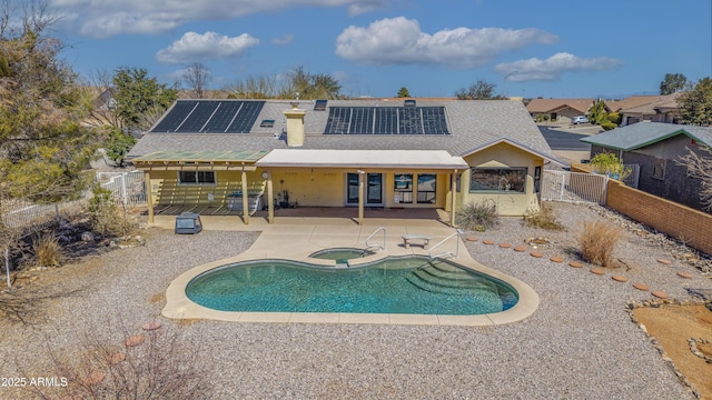 view of swimming pool with a fenced backyard, a fenced in pool, an in ground hot tub, and a patio