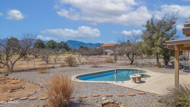 view of pool with a patio area, a fenced in pool, a mountain view, and fence