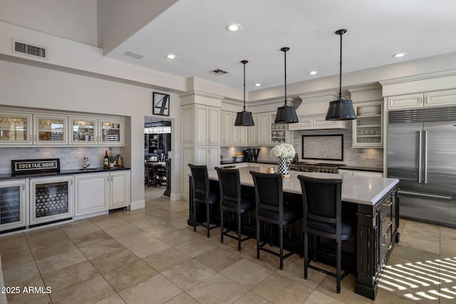 kitchen with sink, decorative light fixtures, a center island, tasteful backsplash, and appliances with stainless steel finishes