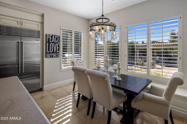 dining room featuring an inviting chandelier and light tile patterned floors