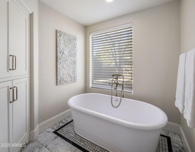 bathroom with tile patterned floors and a bathing tub