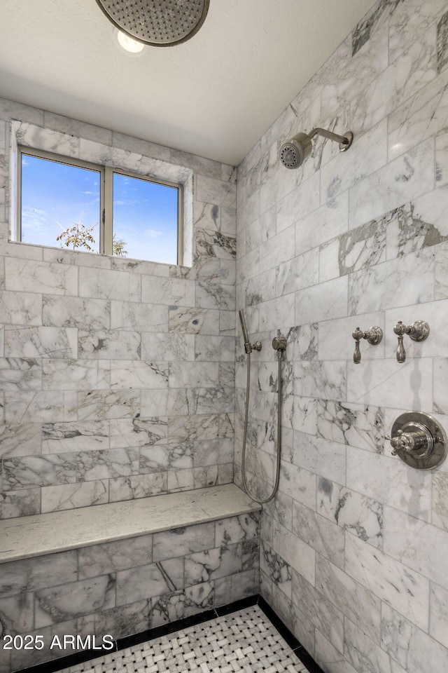 bathroom with a tile shower