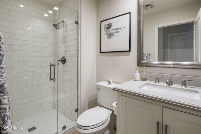 bathroom with toilet, a shower with door, and vanity