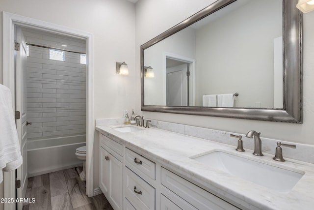 full bathroom featuring toilet, vanity, and tiled shower / bath combo