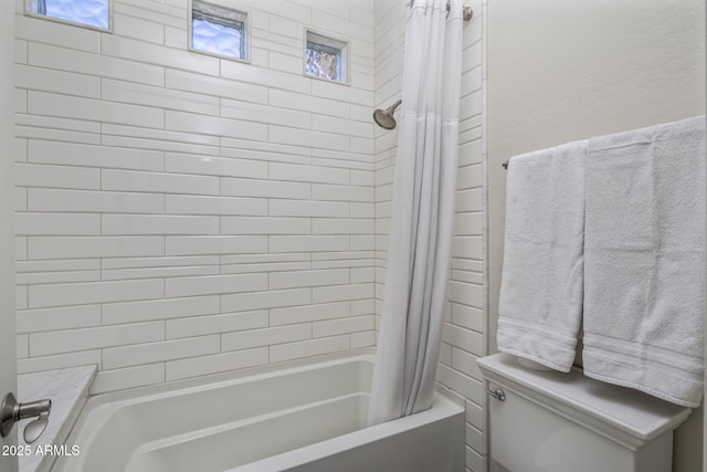 bathroom featuring shower / bath combination with curtain and toilet