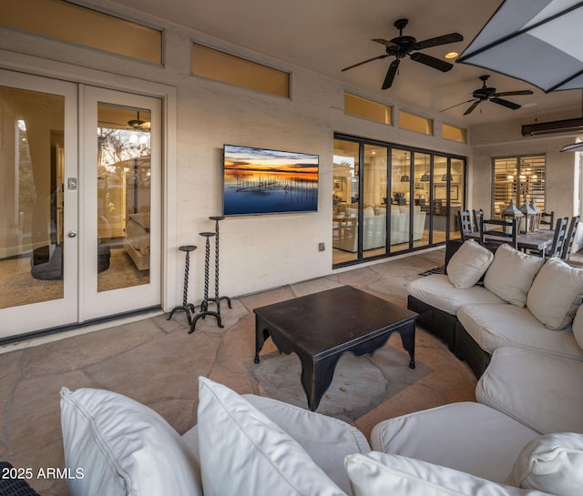 living room featuring ceiling fan and french doors