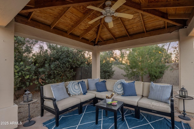 patio terrace at dusk with ceiling fan, a gazebo, and an outdoor living space