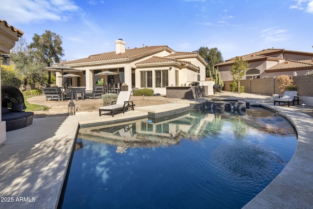 view of pool featuring exterior kitchen and a patio