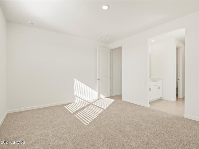 empty room featuring light colored carpet