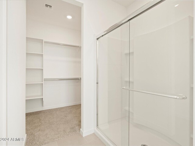 bathroom featuring a shower with shower door