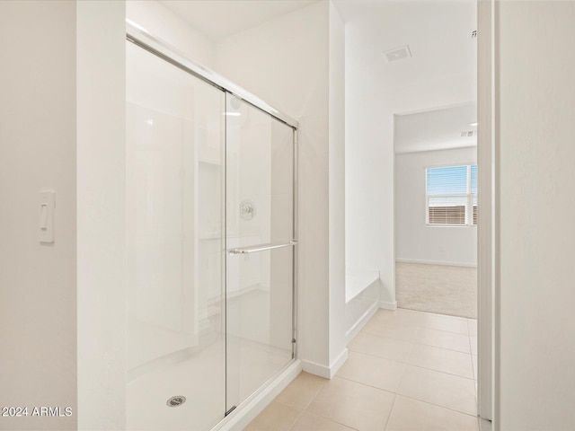 bathroom featuring plus walk in shower and tile patterned floors