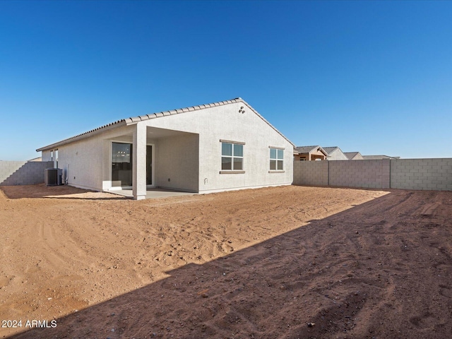 rear view of property with a patio area and central AC