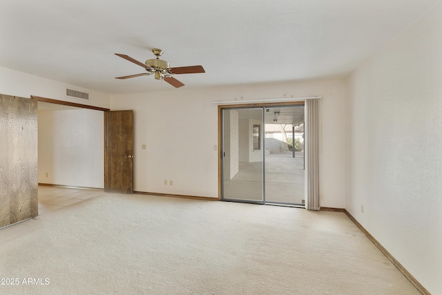 carpeted spare room with ceiling fan