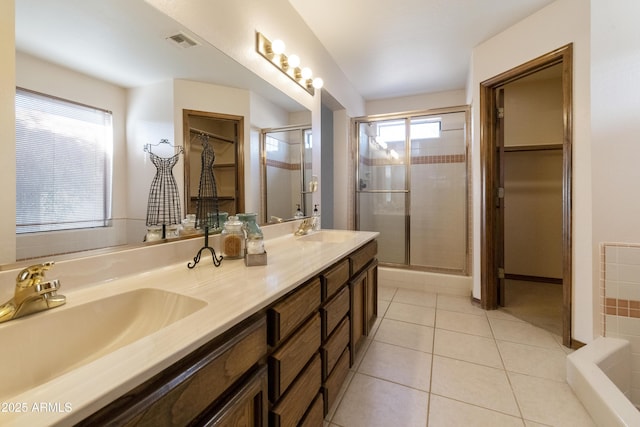 bathroom featuring walk in shower, vanity, and tile patterned flooring