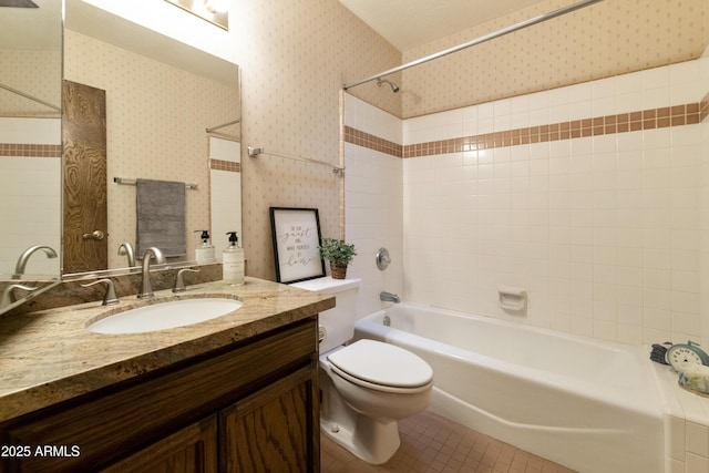 full bathroom with vanity, tiled shower / bath, tile patterned floors, and toilet