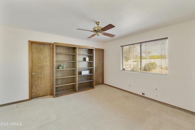 unfurnished bedroom featuring ceiling fan and light carpet