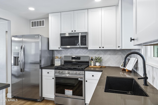 1359 E Nielson Ave, Mesa, AZ 85204 - kitchen with stainless steel appliances, dark countertops, white cabinetry, and recessed lighting