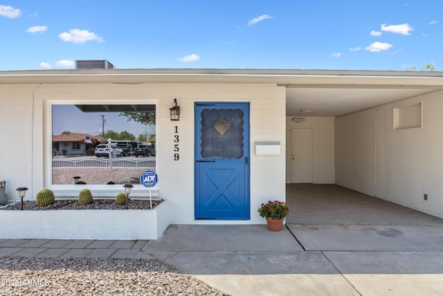 1359 E Nielson Ave, Mesa, AZ 85204 - doorway to property featuring concrete block siding and a carport