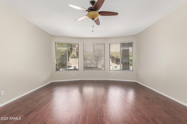 unfurnished room with dark hardwood / wood-style floors and ceiling fan