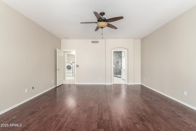 spare room with ceiling fan, washer / clothes dryer, and dark hardwood / wood-style floors