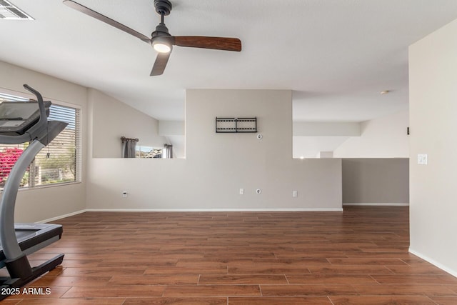 exercise area featuring ceiling fan and dark wood-type flooring