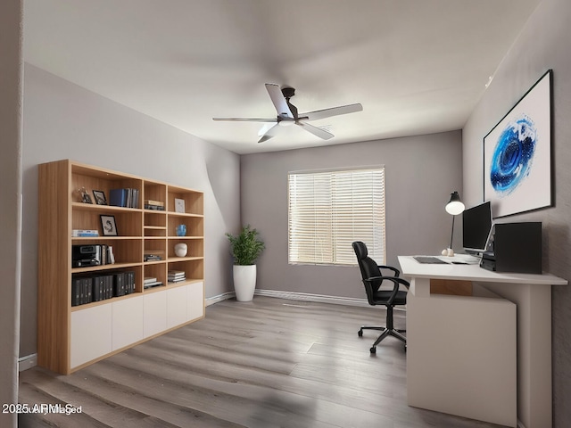 office space featuring ceiling fan, wood finished floors, and baseboards