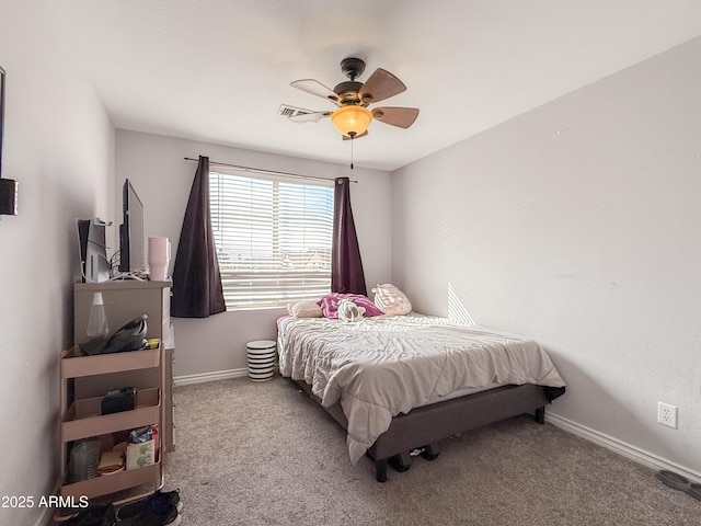 carpeted bedroom with baseboards and a ceiling fan