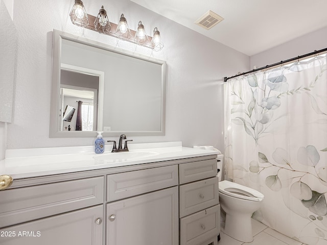 bathroom featuring a shower with curtain, visible vents, vanity, and toilet