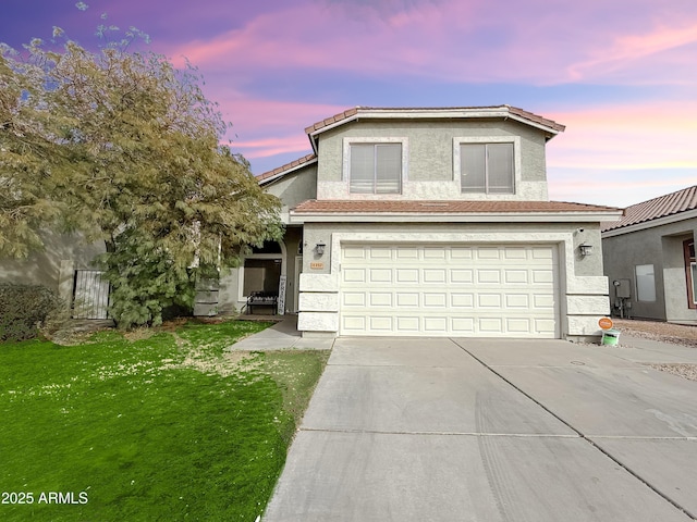 traditional-style house with a garage, concrete driveway, a lawn, and stucco siding