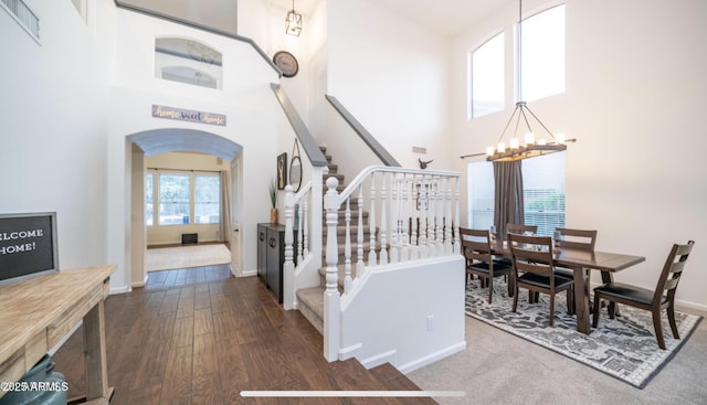 interior space featuring hardwood / wood-style flooring, a chandelier, and a towering ceiling