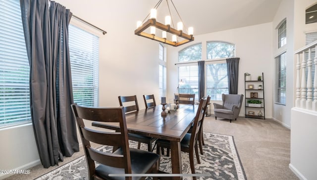 dining room featuring light carpet and an inviting chandelier