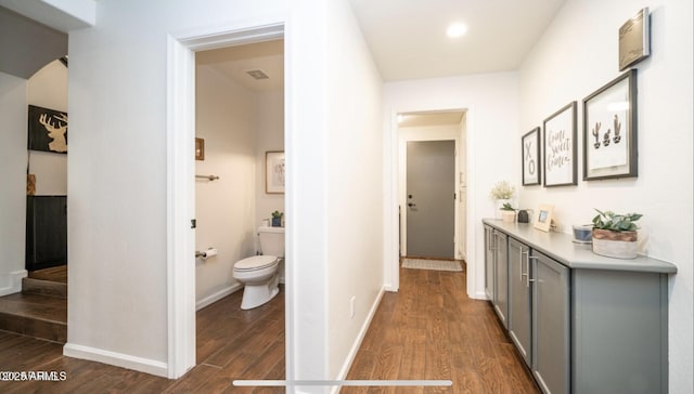 hallway with dark hardwood / wood-style floors