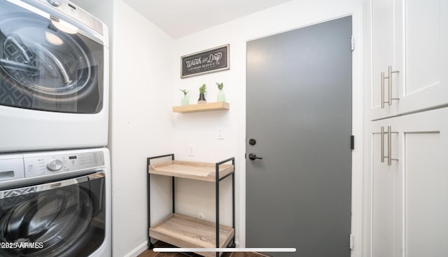 clothes washing area with cabinets and stacked washer / dryer