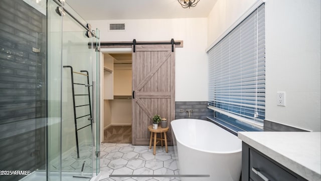 bathroom with plus walk in shower, tile patterned flooring, and vanity