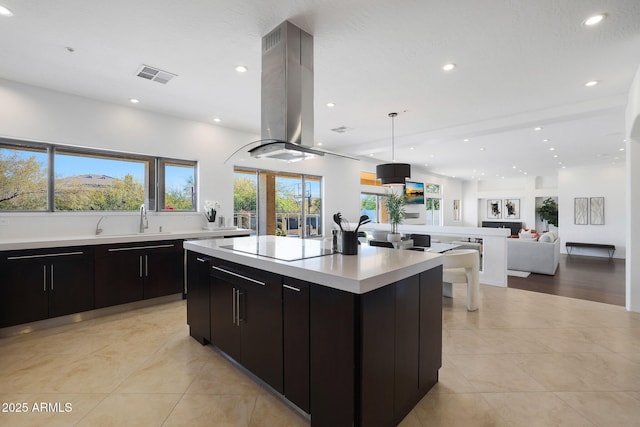 kitchen with a kitchen island, a healthy amount of sunlight, island range hood, and black electric stovetop