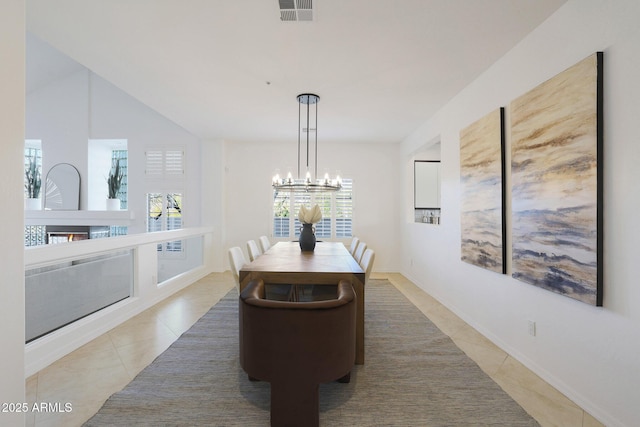 tiled dining room featuring a notable chandelier