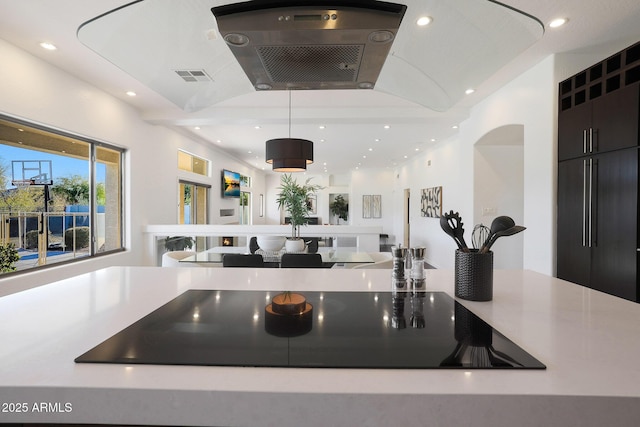 interior space with hanging light fixtures and black electric cooktop