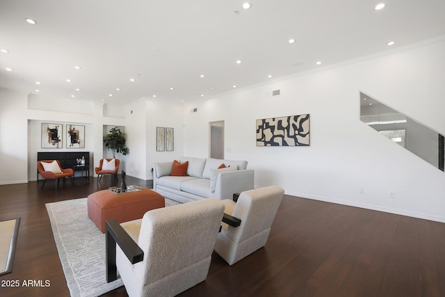 living room featuring dark hardwood / wood-style floors and ornamental molding