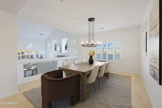 dining space with a chandelier and light tile patterned floors