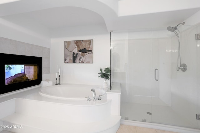 bathroom with independent shower and bath, a multi sided fireplace, and tile patterned flooring