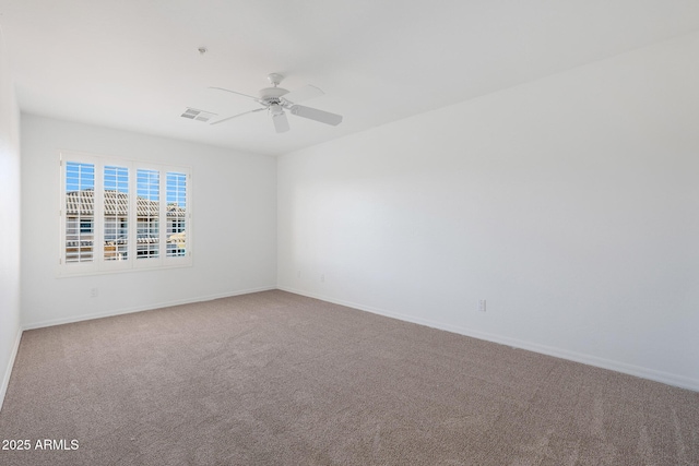 carpeted spare room featuring ceiling fan