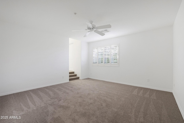 unfurnished room featuring ceiling fan and carpet flooring