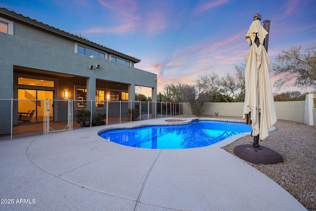 pool at dusk with a patio