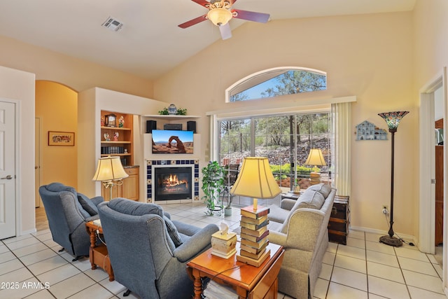 709 W Forest Dr, Payson, AZ 85541 - living area with a ceiling fan, visible vents, a fireplace, high vaulted ceiling, and light tile patterned flooring