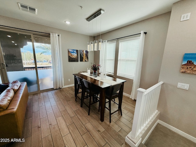 dining space with baseboards, visible vents, wood finished floors, and recessed lighting