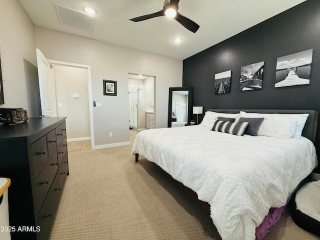 bedroom with recessed lighting, light colored carpet, visible vents, ensuite bathroom, and baseboards