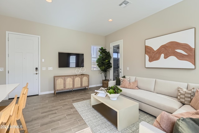 living area with visible vents, recessed lighting, baseboards, and wood finish floors