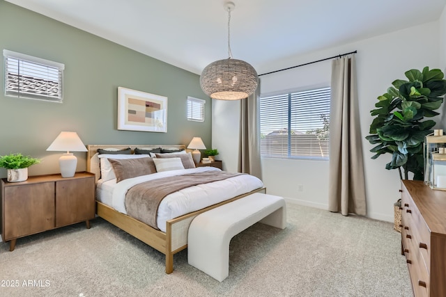 bedroom featuring baseboards and light colored carpet