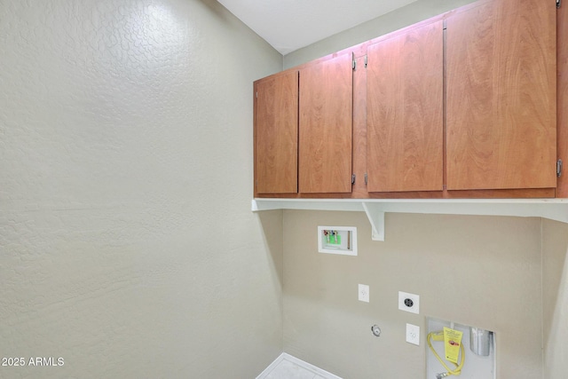 washroom featuring electric dryer hookup, hookup for a gas dryer, hookup for a washing machine, and cabinets